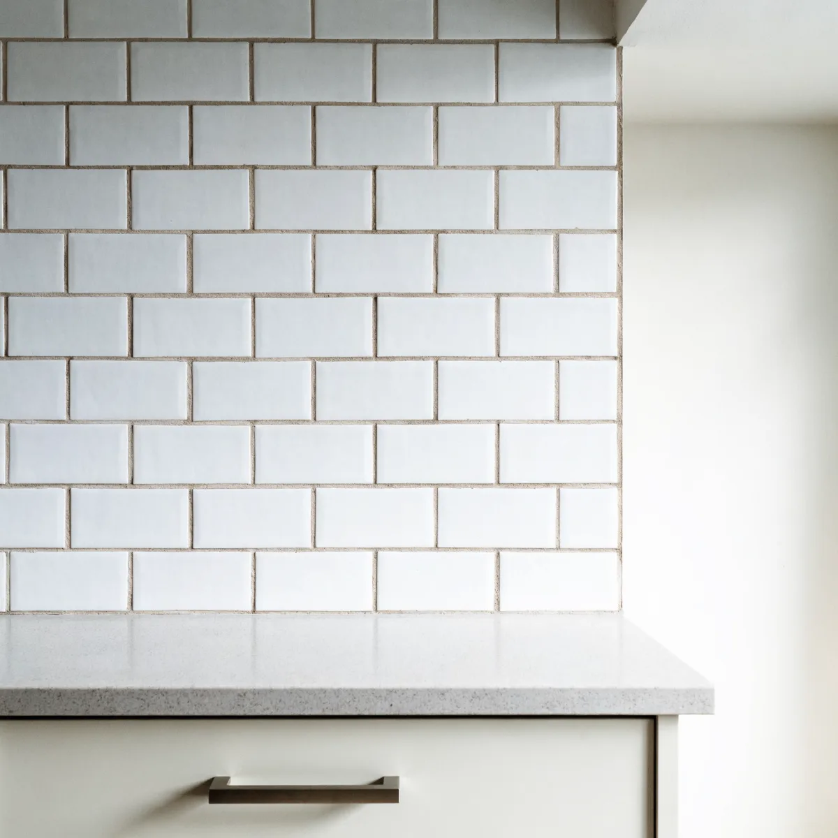 The same wall in three by six subway tile, the same white with the grout lines spaced much further apart