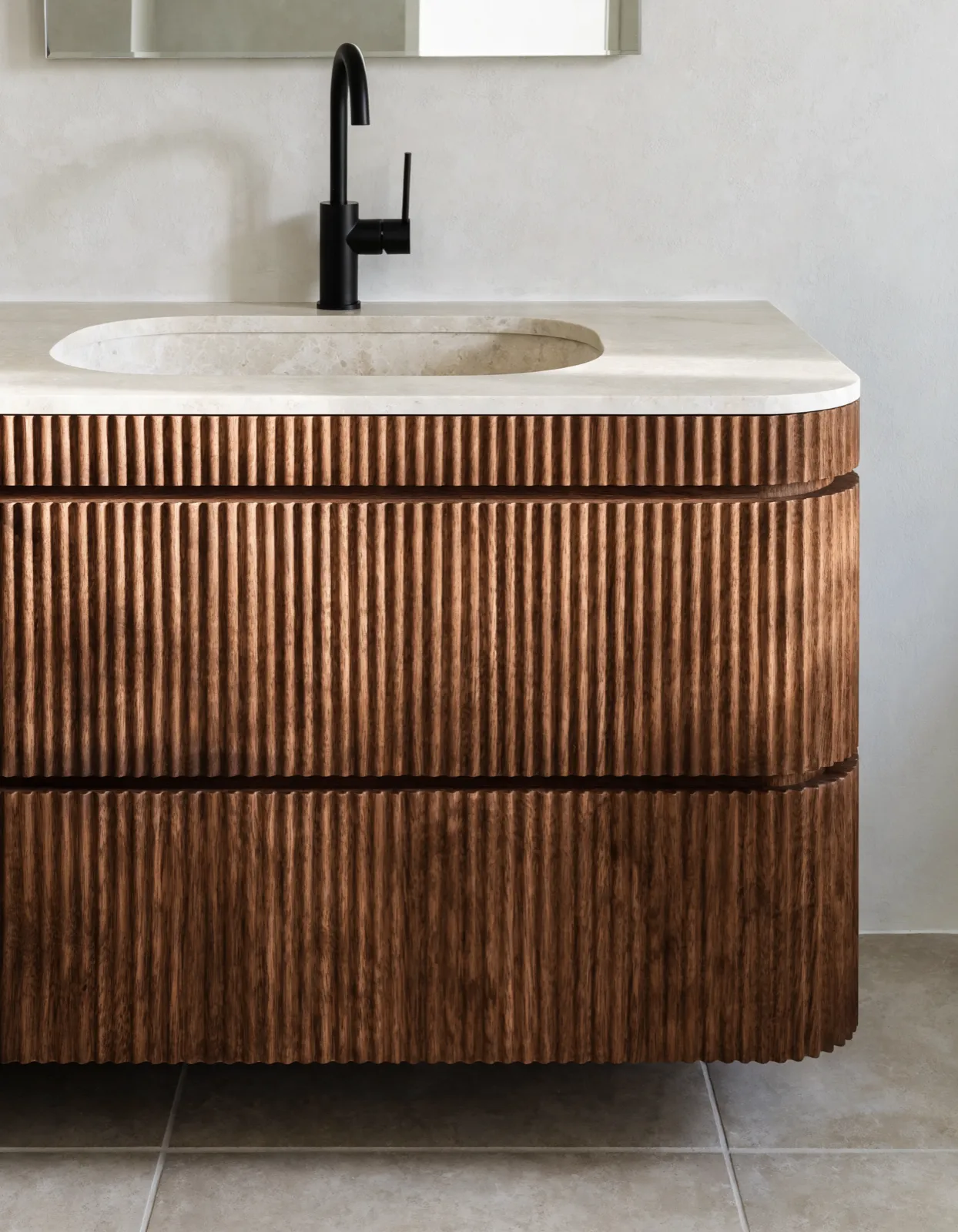 Bathroom vanities Davie, FL: a two-drawer vanity with a stone top and an undermount sink, the faucet and the mirror above it