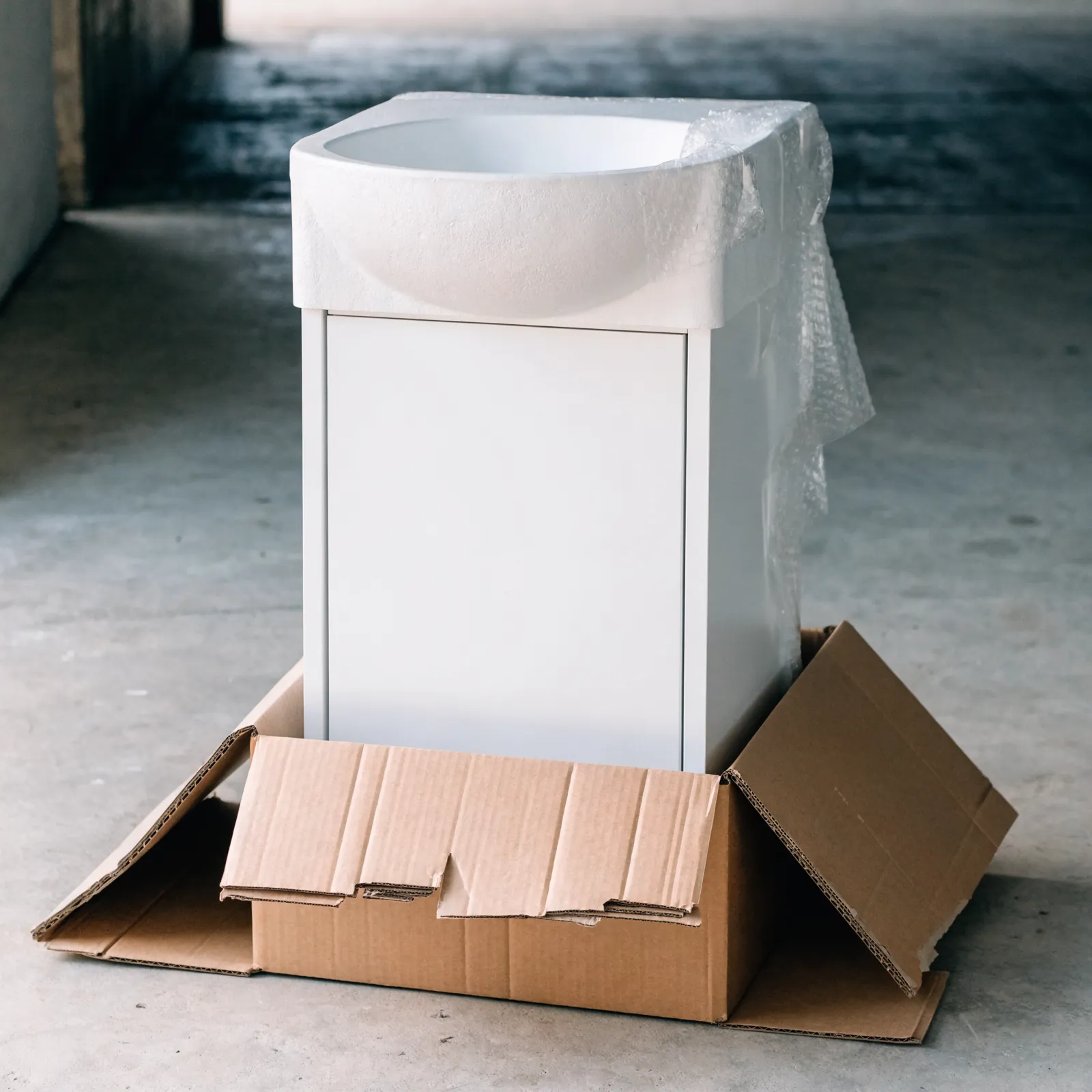 A stock vanity delivered as one piece, the cabinet, the top and the bowl already assembled and boxed
