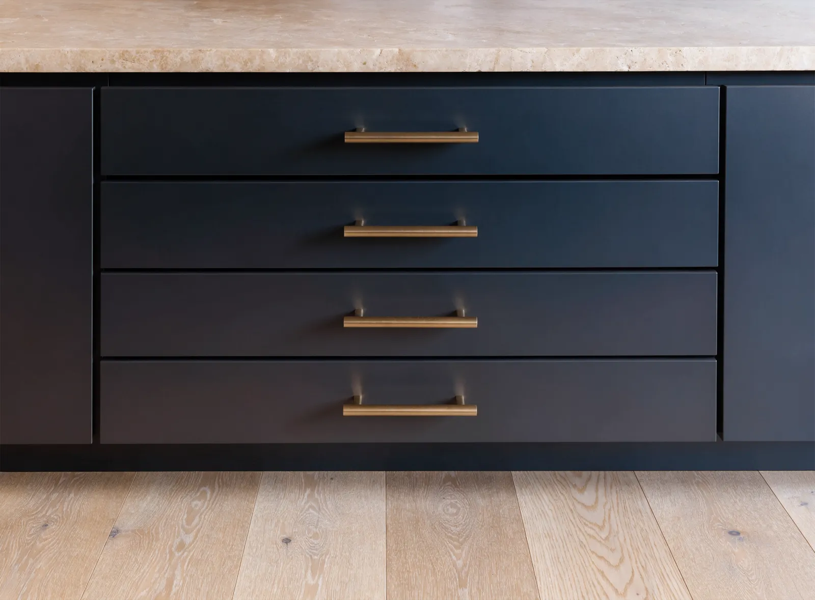 A bank of four drawers in a Davie kitchen after new pulls went on, the four pulls reading as one line down the stack