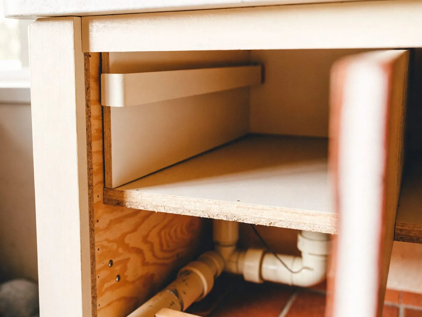 Cabinet maker in Davie, FL: an opened sink base showing the condition of the cabinet box