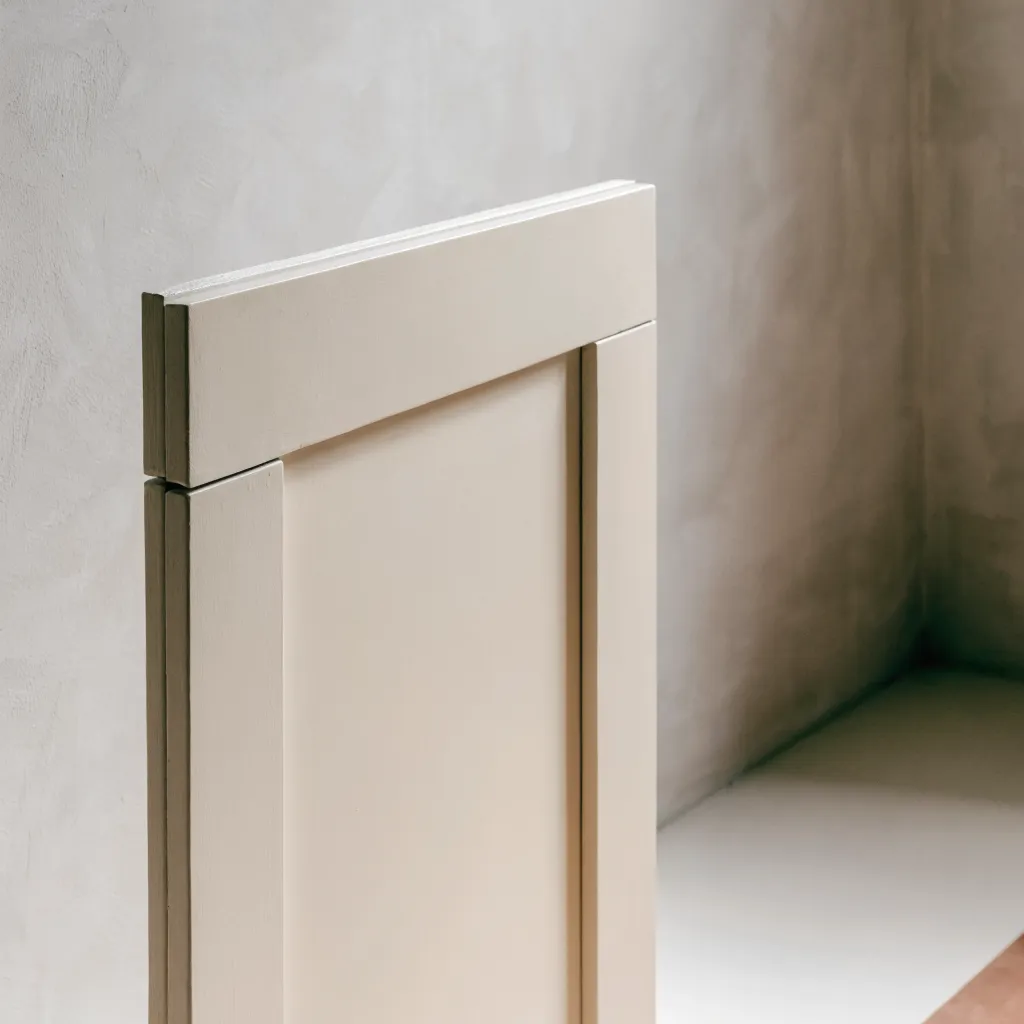 A painted five-piece door built from solid stock, the joint where the top rail meets the stile reading at the corner