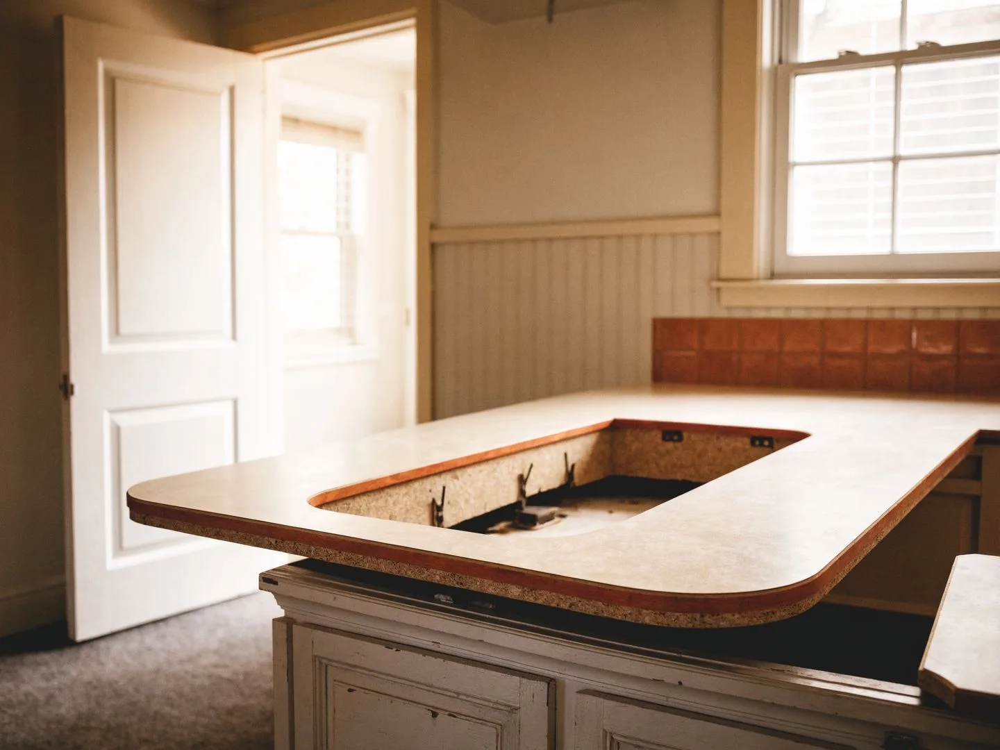 Countertop contractor in Davie, FL: an old laminate top lifted off to show the particleboard deck underneath