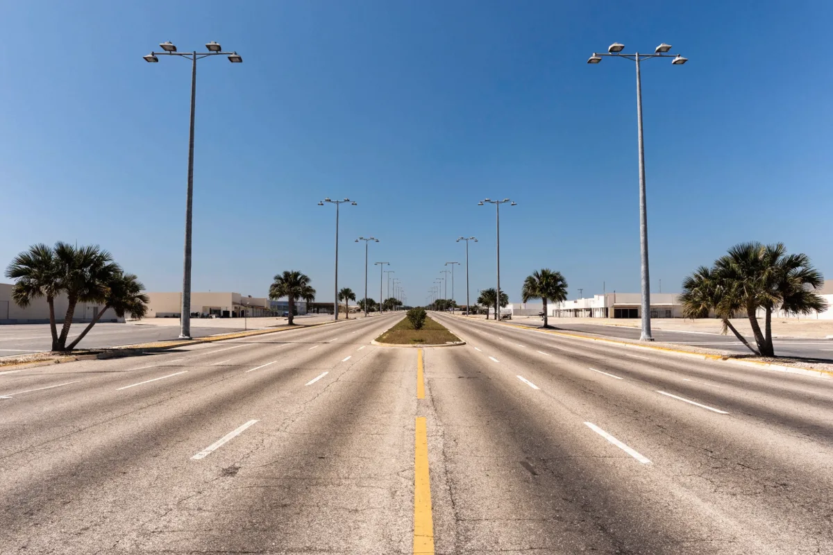 The State Road 7 corridor in Davie, a wide roadway with tall light poles and palms along the curb