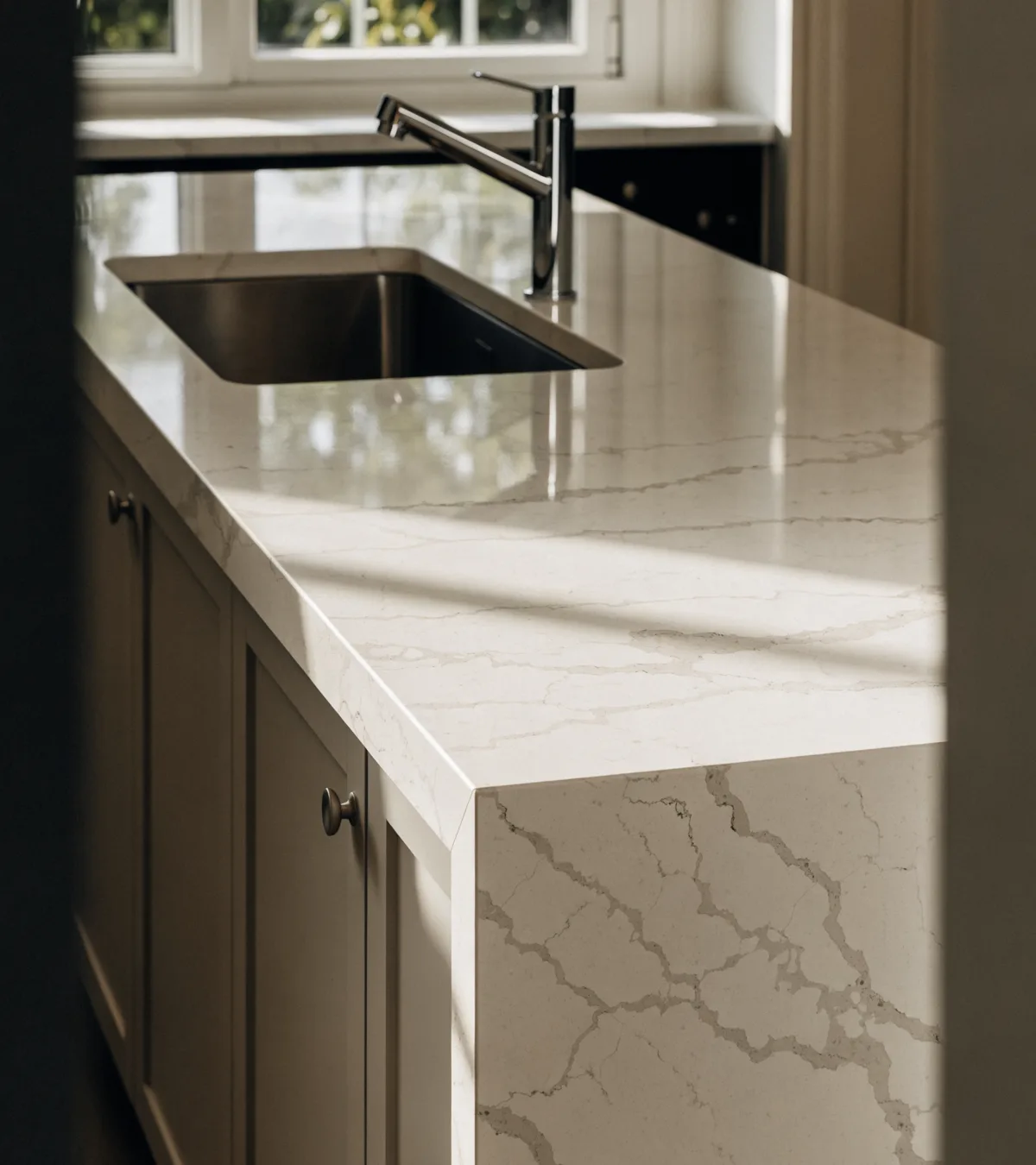 Countertop contractor near Pine Island Ridge in Davie: a finished quartz counter run with a mitered waterfall edge and an undermount sink