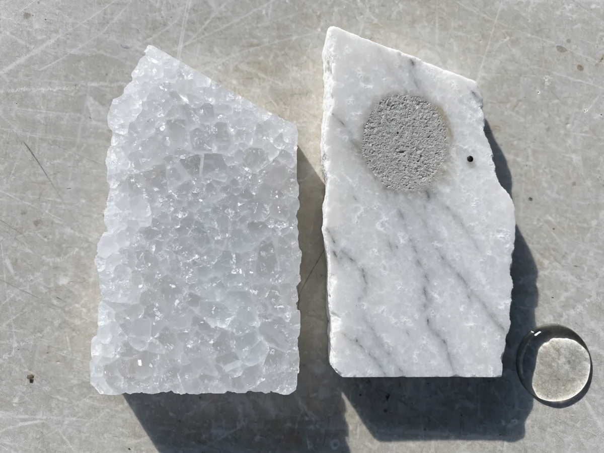 Two white stone samples compared side by side near Pine Island Ridge in Davie, one crystalline quartzite and one dolomitic marble with an etched spot