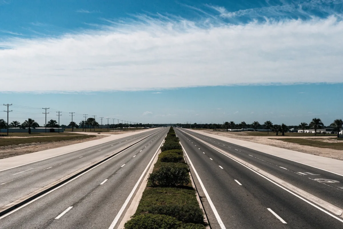 State Road 7 in Davie, a wide arterial with a planted median and open sky, just north of where Griffin Road ends