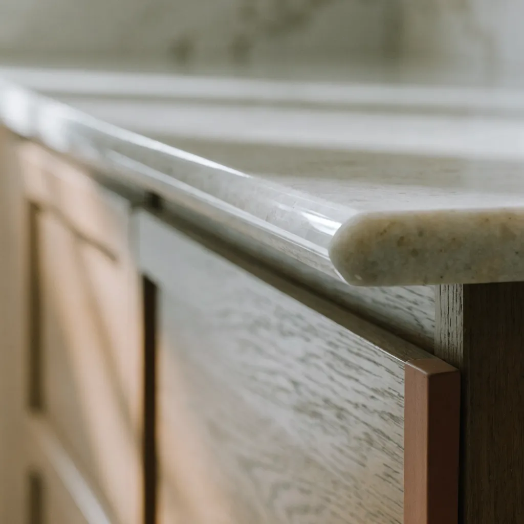 The three centimeter edge of a new top overhanging the face of the original cabinets in a Davie kitchen