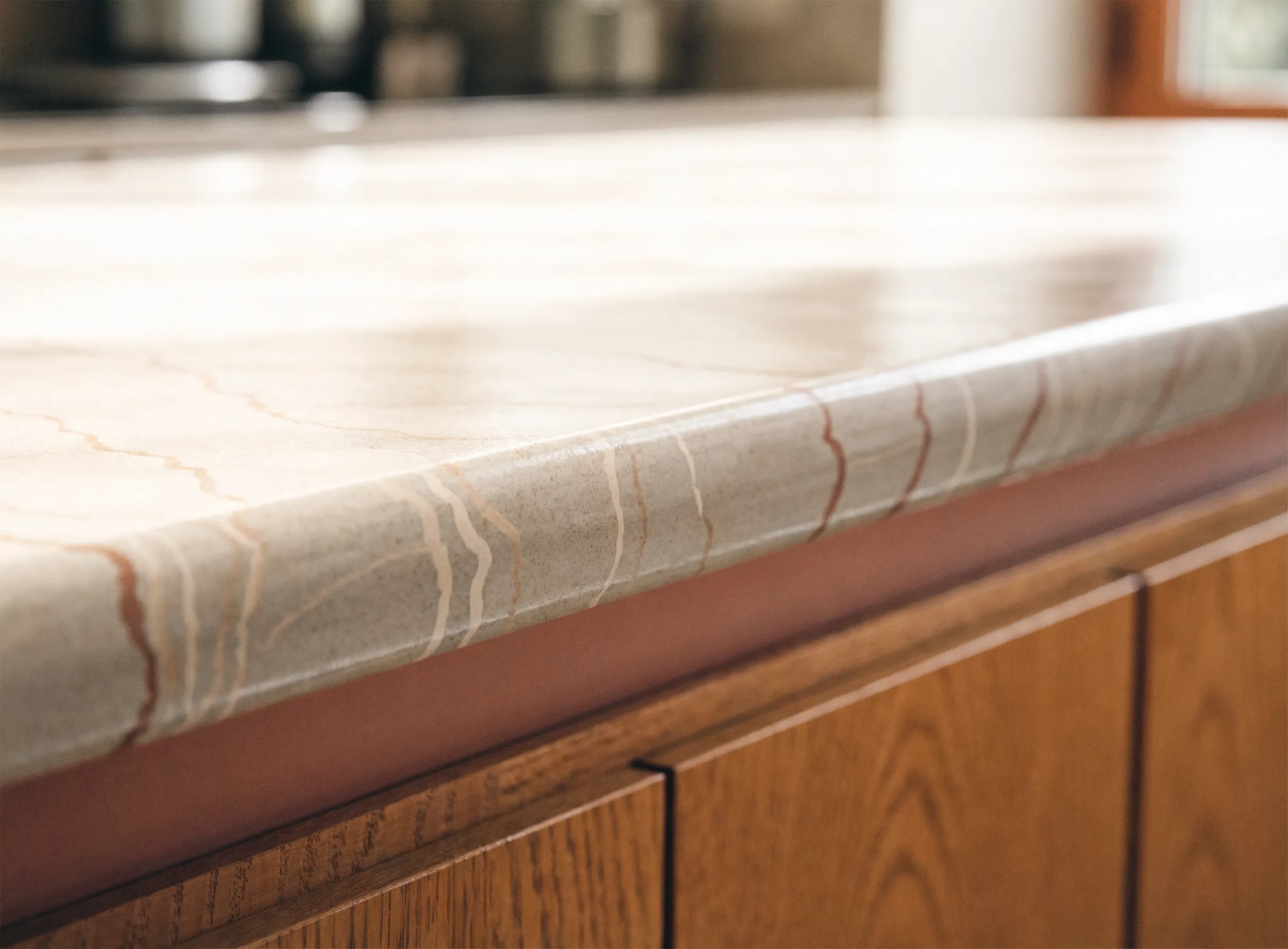 Countertop resurfacing in Davie, FL: the edge of a resurfaced counter, the new coating carried over the rolled profile of the laminate underneath