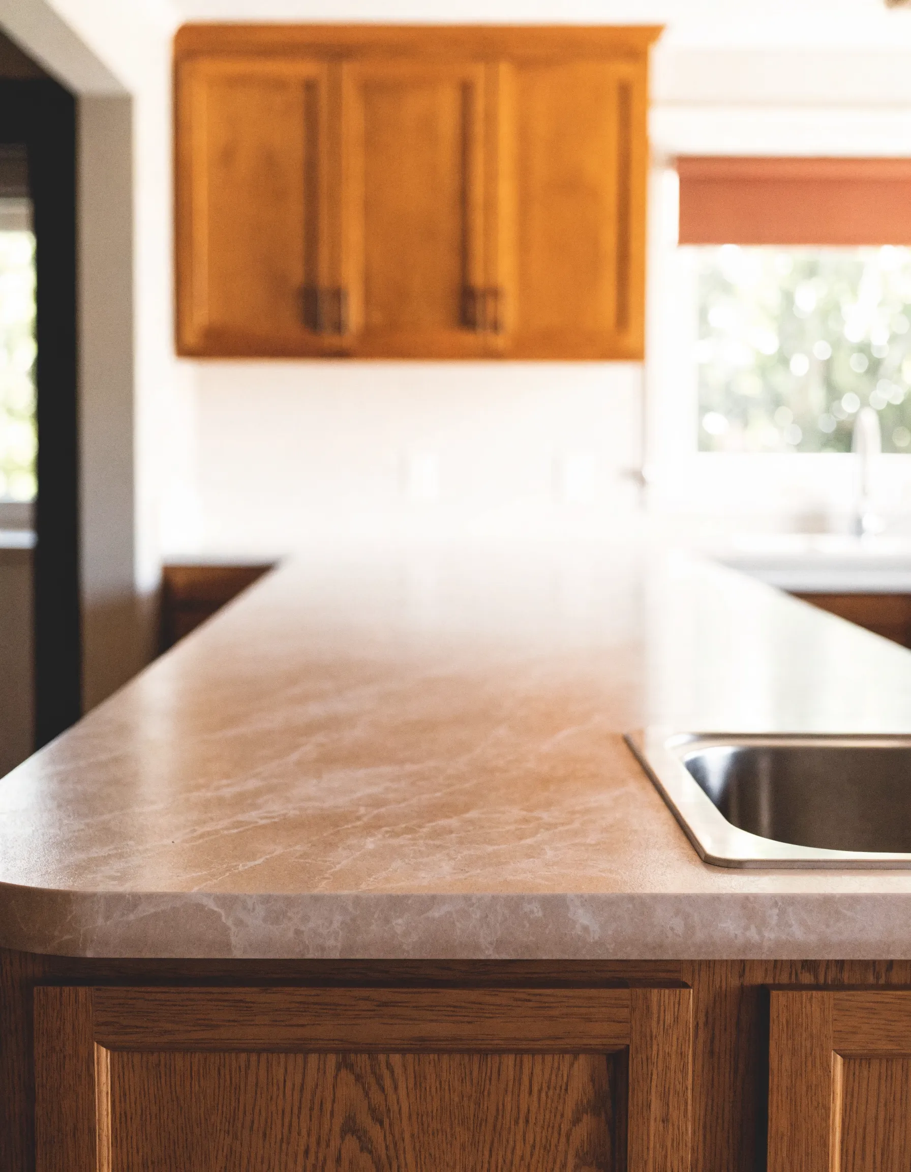 Countertop resurfacing Davie, FL: a resurfaced counter run in a warm stone-look finish with the original cabinets underneath