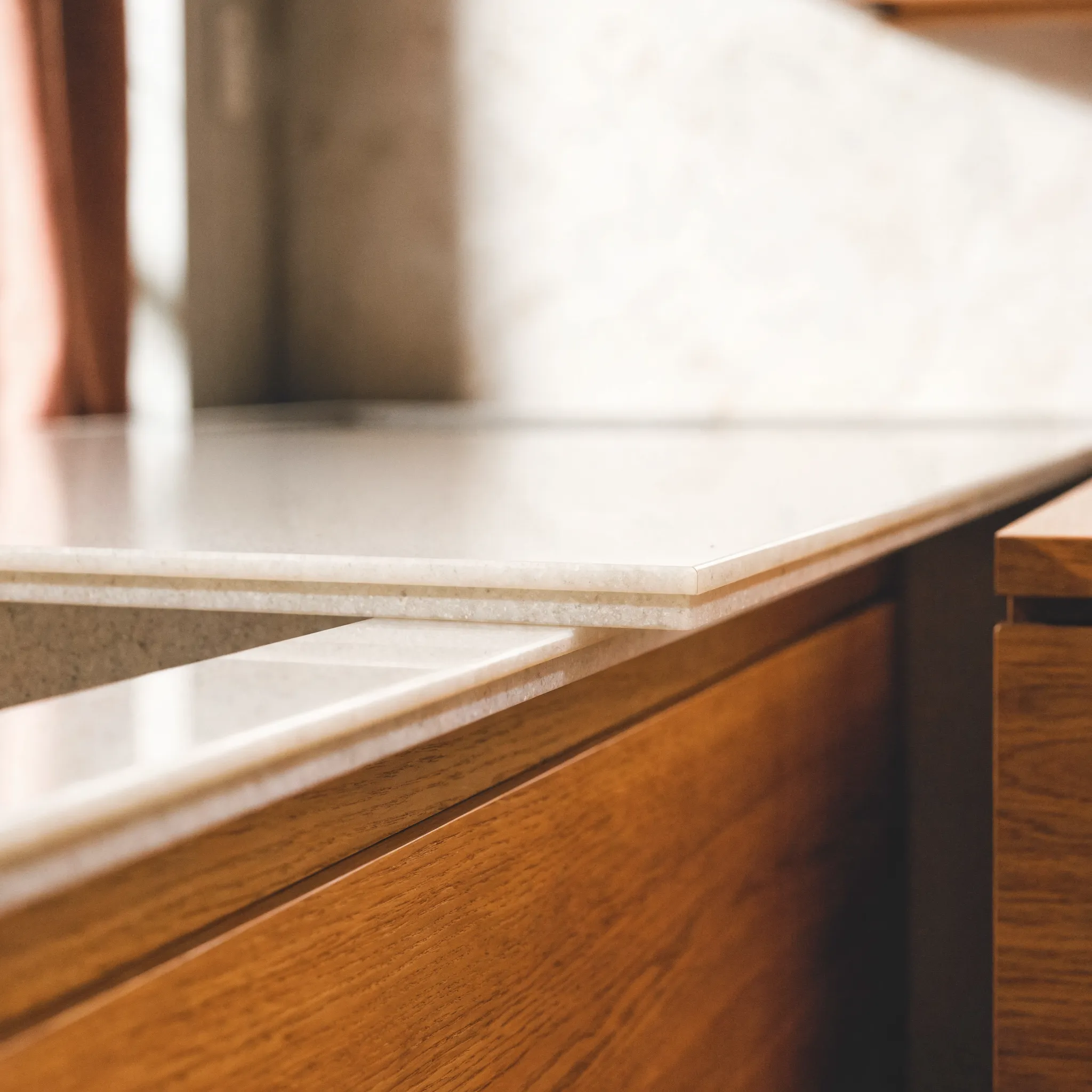 A quarter inch engineered stone overlay set over an existing counter, the doubled edge visible at the profile