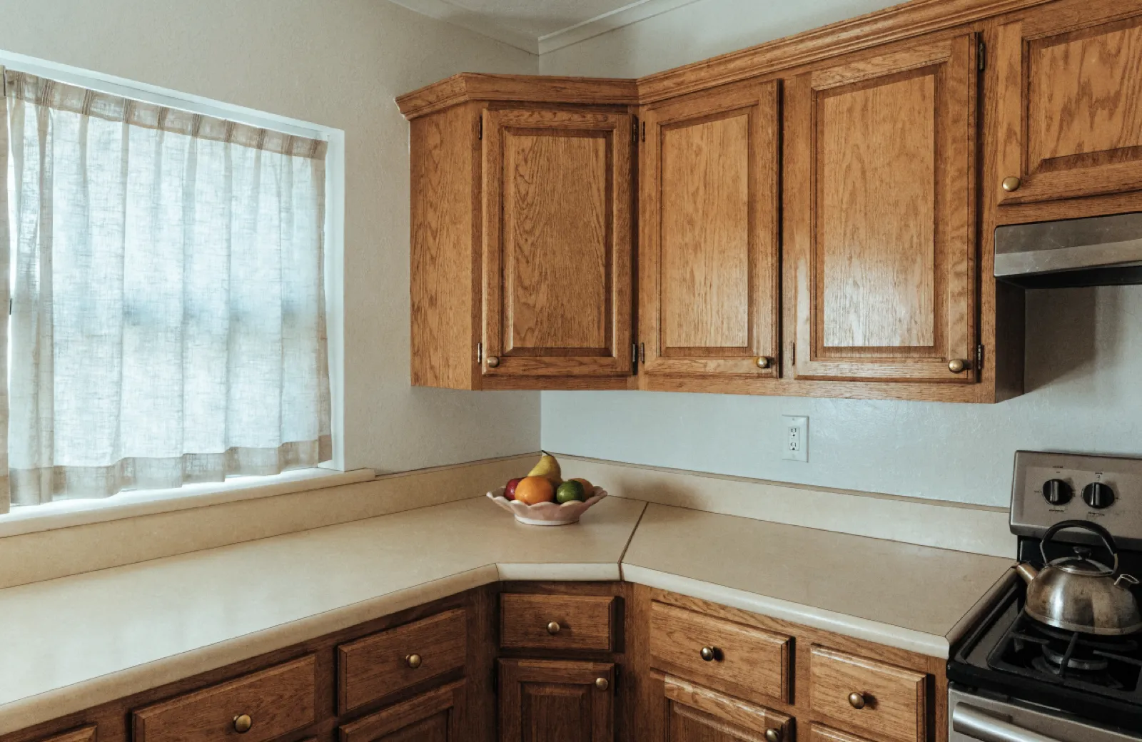 The corner of a 1980s Davie kitchen where the original cabinet run meets the wall at an angle and the counter was cut to follow it