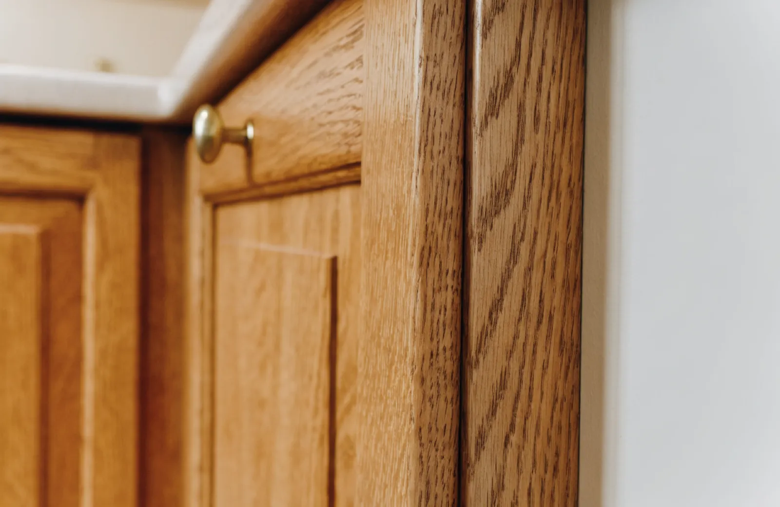 A three-inch filler strip closing the gap between a stock cabinet and the wall of a Davie kitchen, painted to match and still visible