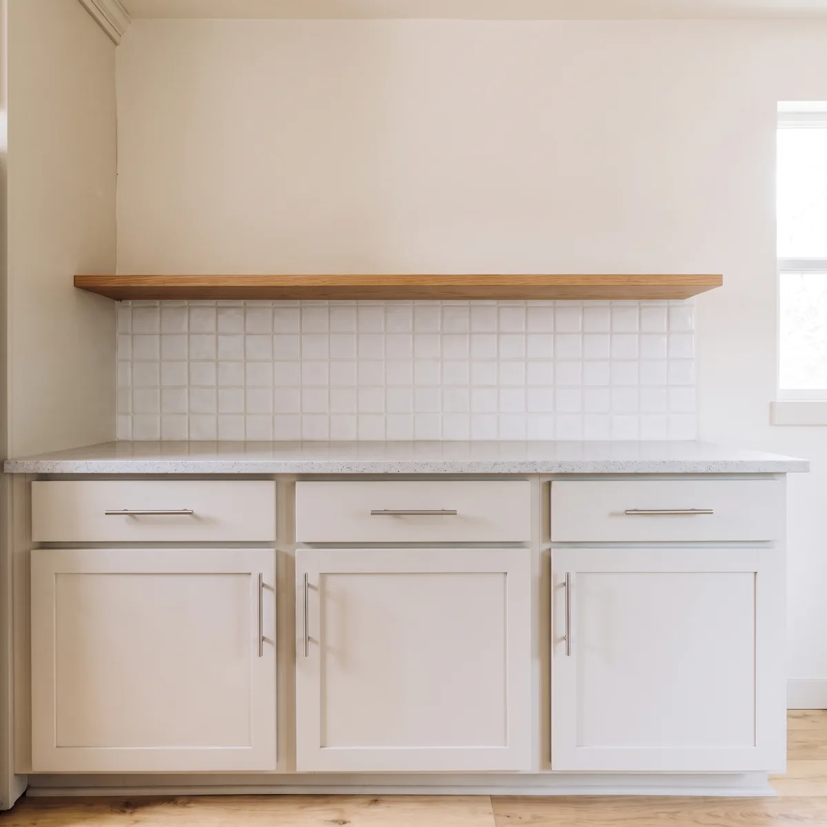 One run of a Davie galley with no wall cabinets above it, a single shelf on the painted wall and the counter clear below