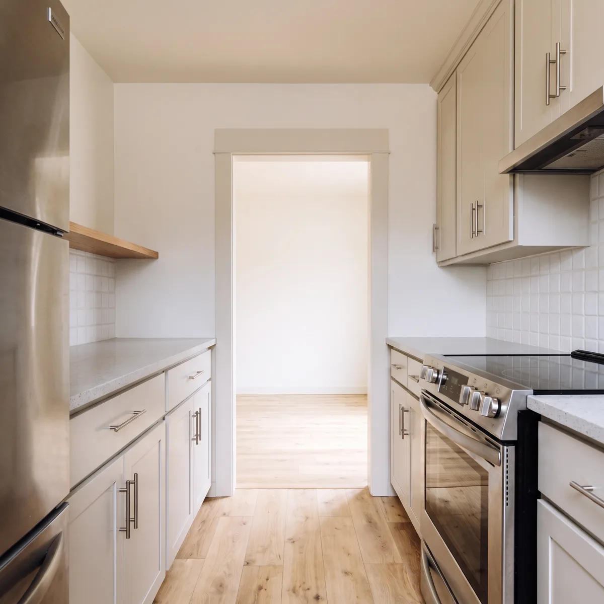 The open end of a Davie galley kitchen, a cased opening the full height of the wall where a doorway used to be
