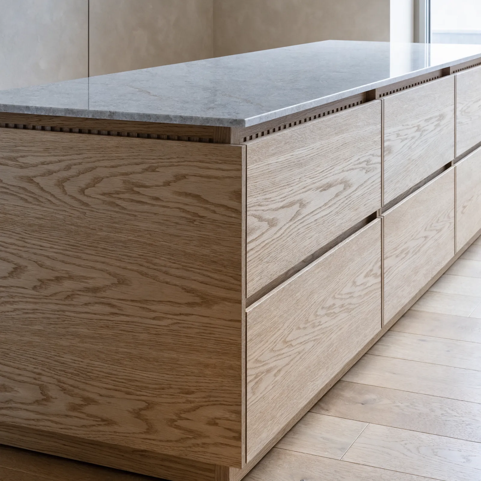 A storage island: base cabinets only, a bank of deep drawers on one side and a flat paneled back on the other, with no sink and no appliance in it