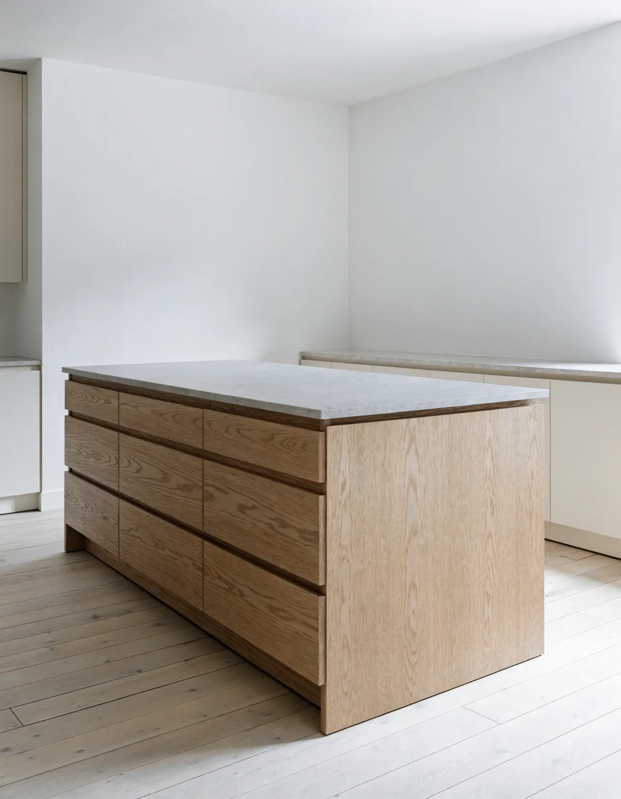 Kitchen island cabinetry Davie, FL: a finished island base standing free in the middle of the room, drawer banks on the working side and a paneled back on the seating side
