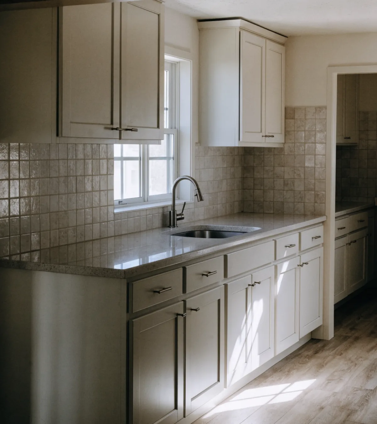 Kitchen remodeling near Bergeron Rodeo Grounds in Davie: a finished kitchen with painted shaker cabinets and a quartz counter in a single story house