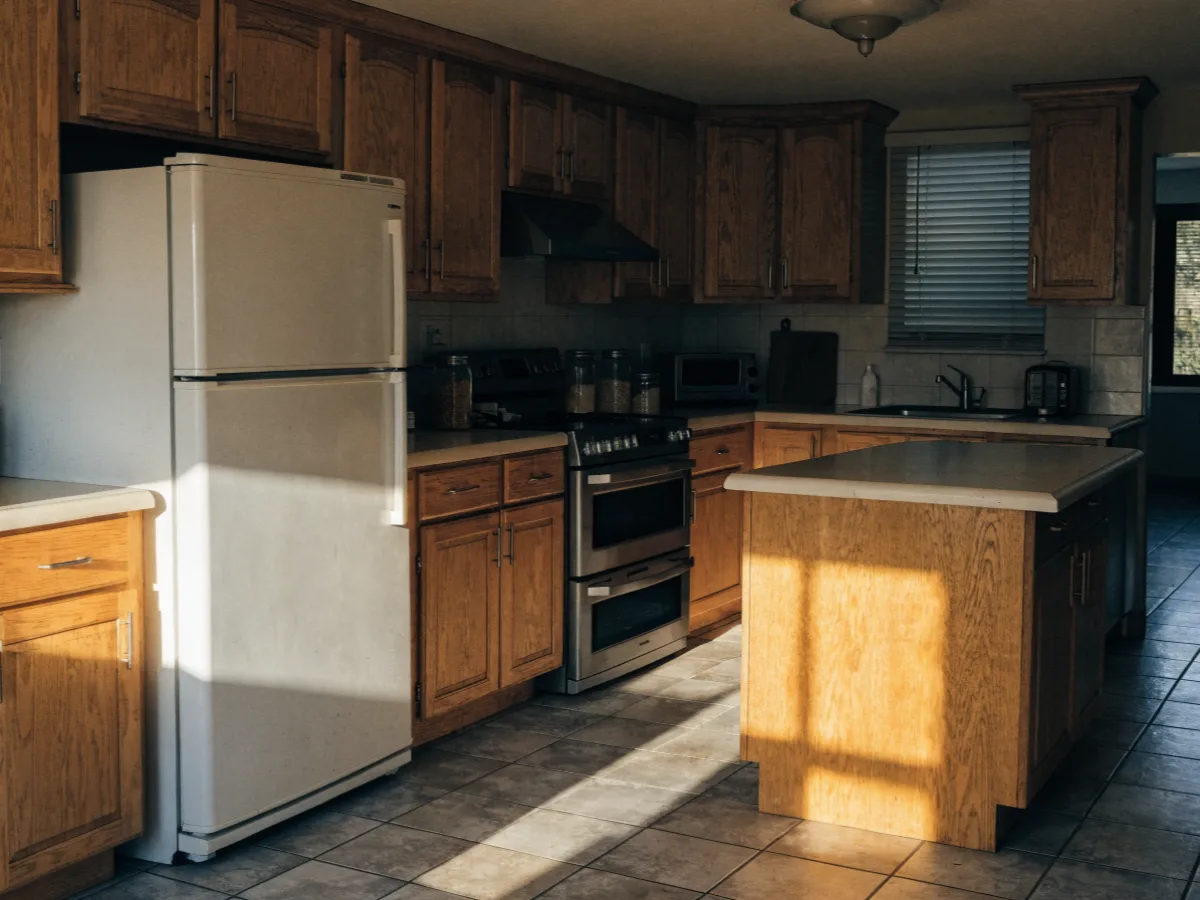 Kitchen remodeling near Flamingo Gardens in Davie: an original mid 1980s kitchen in a four bedroom house, oak fronts on a long run, laminate counters and a center island