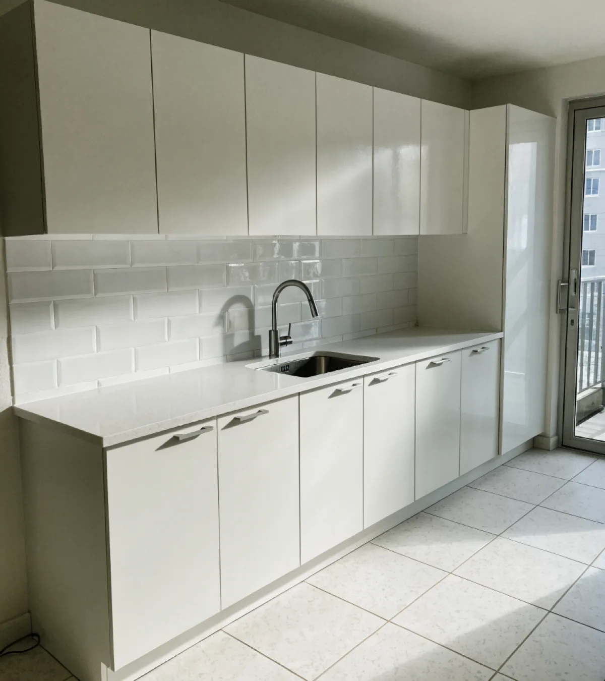 Kitchen remodeling near Nova Southeastern University in Davie: a finished condominium kitchen with a single wall run, flat panel fronts and a quartz counter