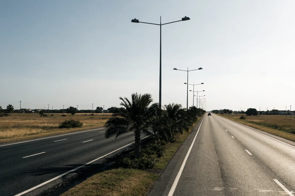 Griffin Road heading east in Davie, four lanes with a planted median and high mast lighting over the traffic