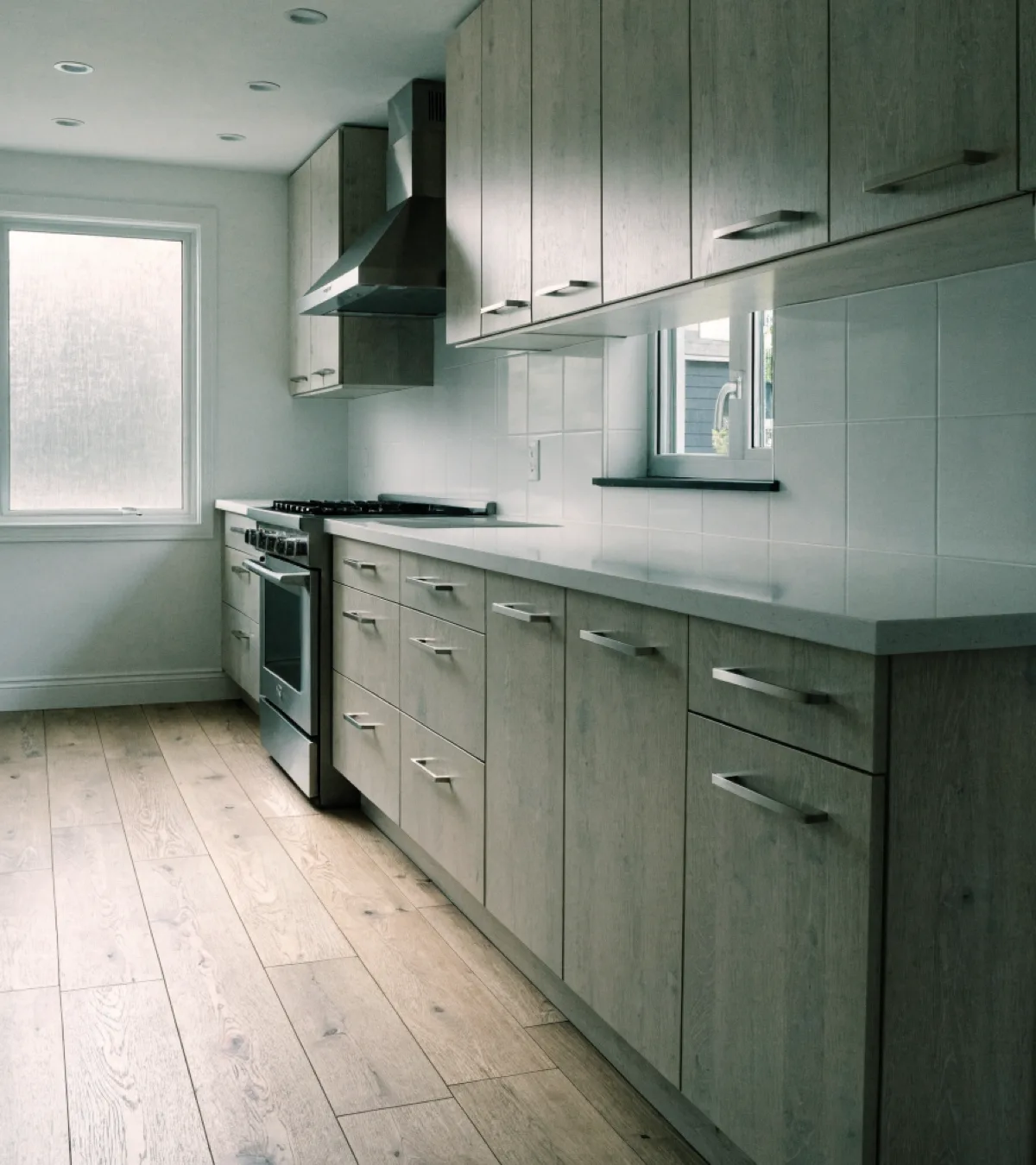 Kitchen remodeling near Western High School in Davie: a finished kitchen with pale washed oak shaker cabinets and a white quartz counter in a two story house from the late 1990s