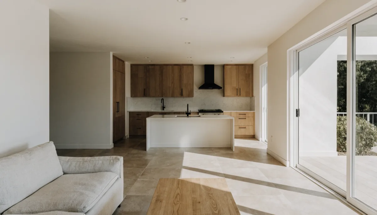 Open concept kitchen remodeling Davie, FL: one shared room with the living area in front and the kitchen at the far end, the white ceiling running through without a bulkhead where a wall used to be