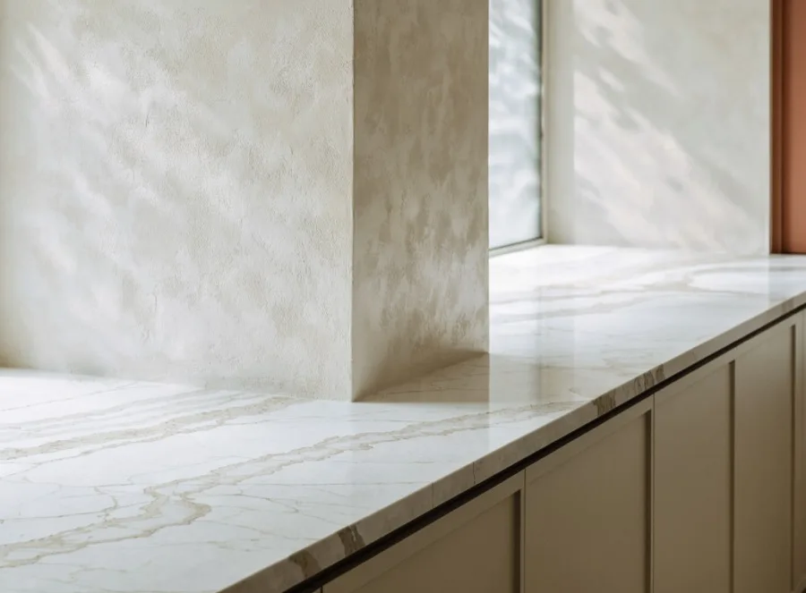 A quartz run carried around an inside corner onto the second wall with the veining matched across the joint